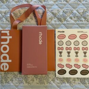 Rhode IPhone 14 Pro Case in Ribbon, Sticker Sheet, and a Bag with Tissue Paper